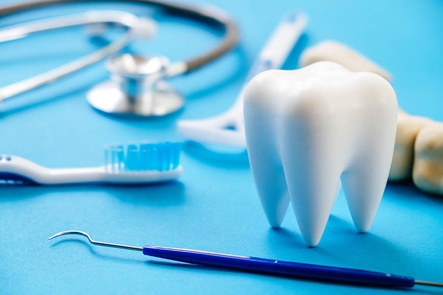 Dental Model And Dental Equipment On Blue Background, Concept Im